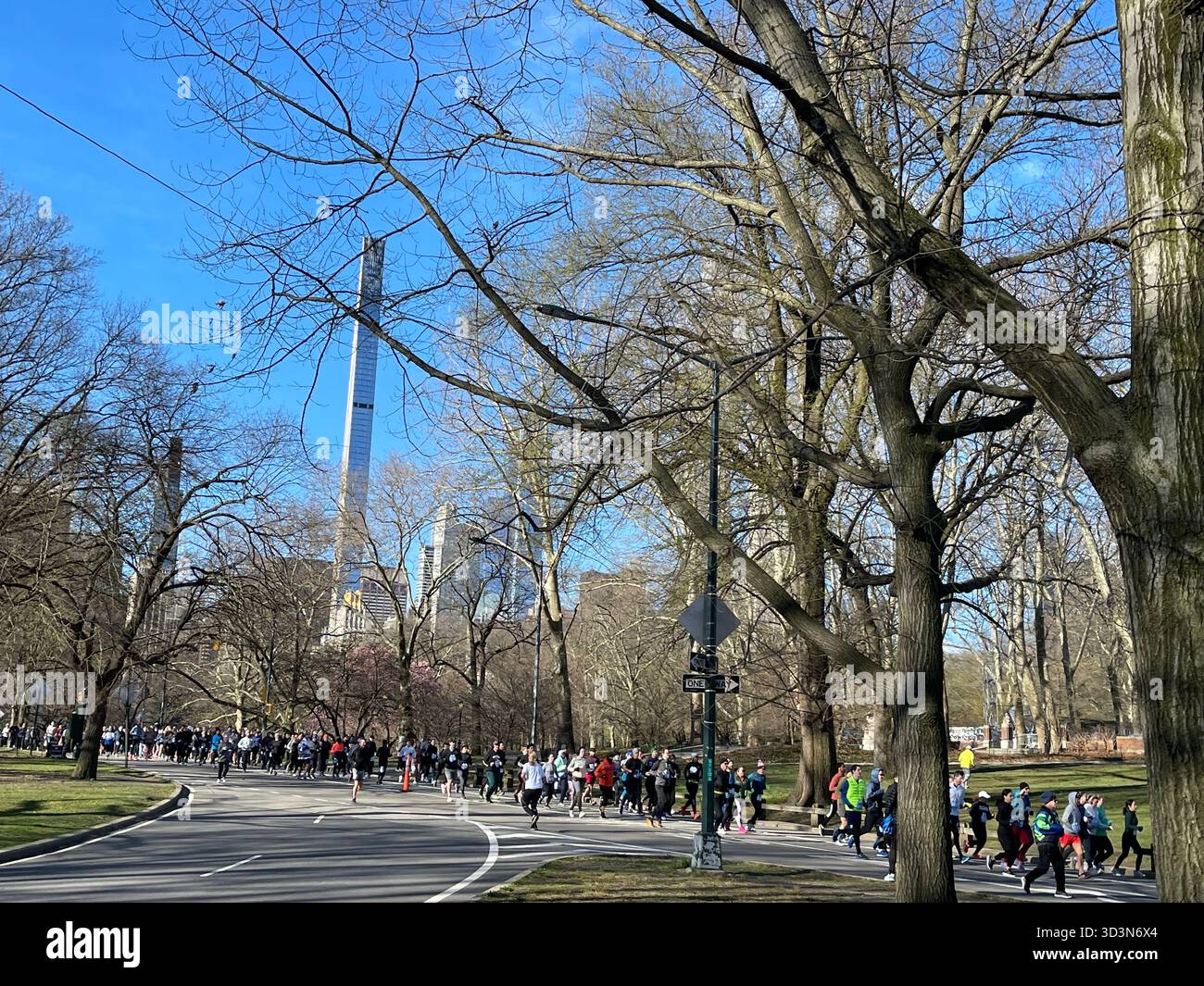 Early morning runners energize Central Park as the sun rises. - Smartphone Captured Stock Image
