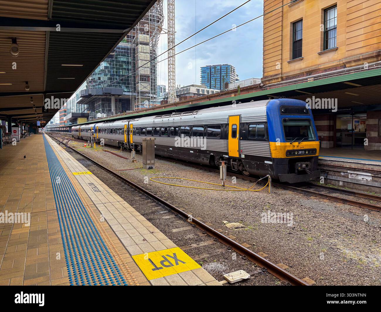 XPT train 2813 at Central Station, Sydney. A blue, yellow, and silver ...