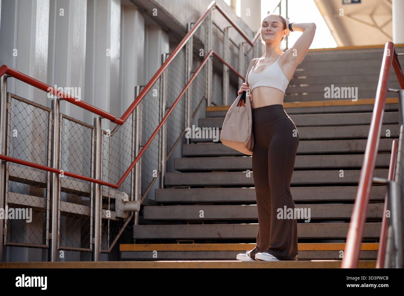 Woman in Activewear on Urban Stairs Stock Photo
