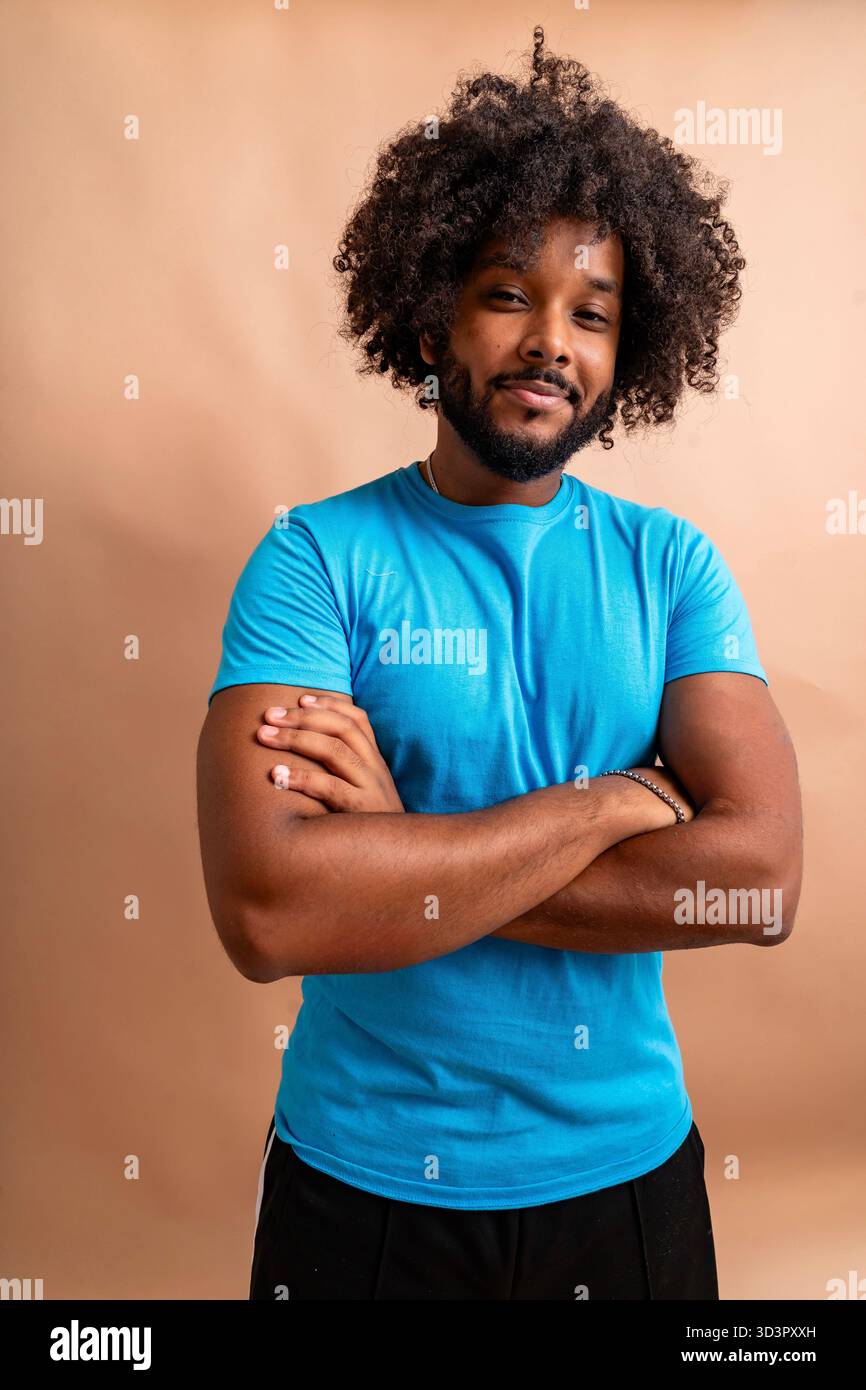 Confident black man smiling with arms crossed Stock Photo