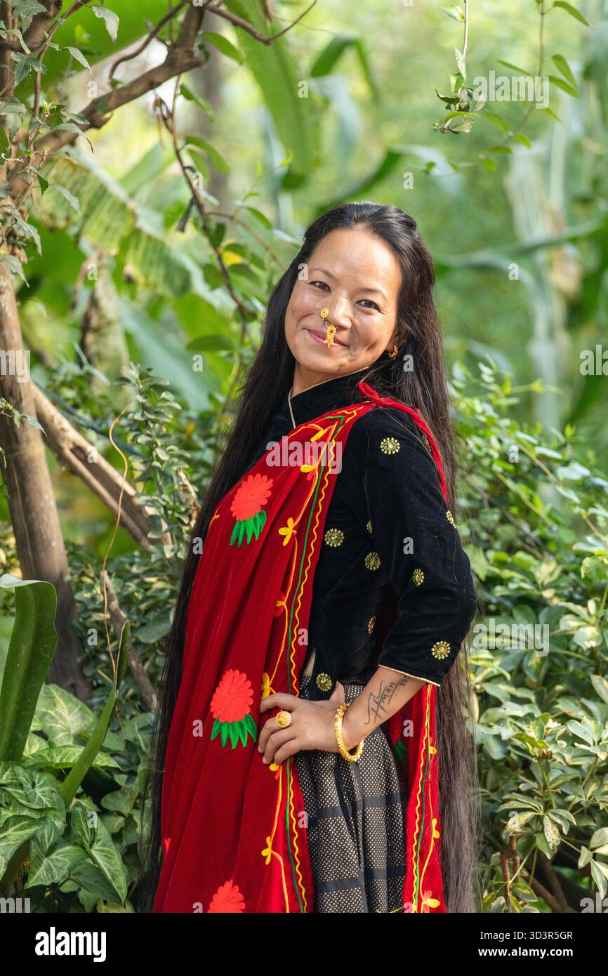 A Nepali woman in traditional dress poses gracefully outdoors. Her vibrant red scarf adorned with floral patterns, set against green foliage, highligh Stock Photo - Alamy A Nepali woman in traditional dress poses gracefully outdoors. Her vibrant red scarf adorned with floral patterns, set against green foliage, highligh Stock Photo - Alamy