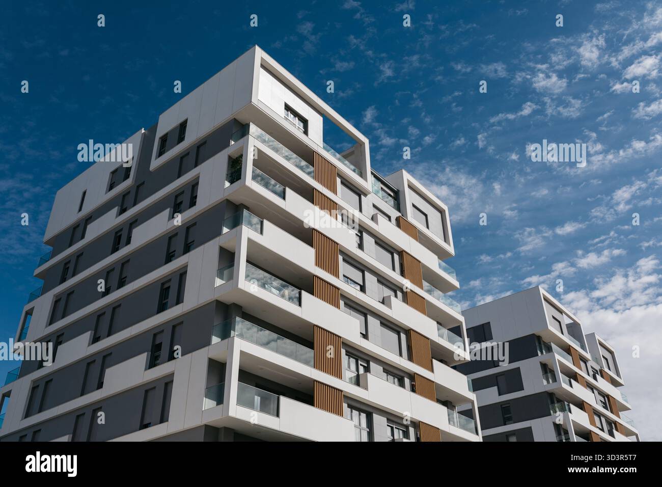 Contemporary apartment buildings with sleek architecture set against a ...