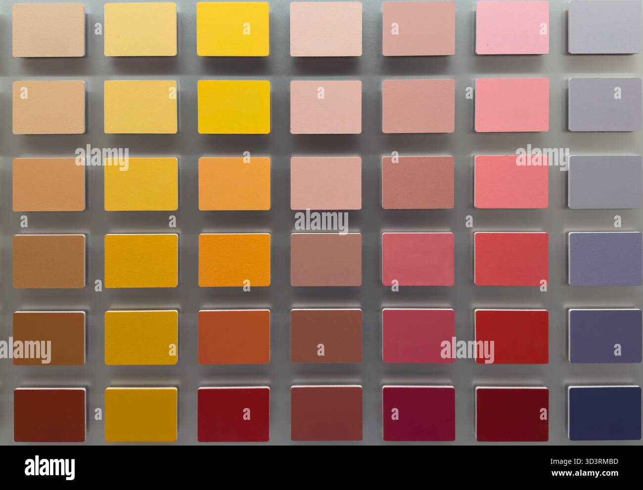Color palette with pink red and yellow paint samples arranged in grid ...