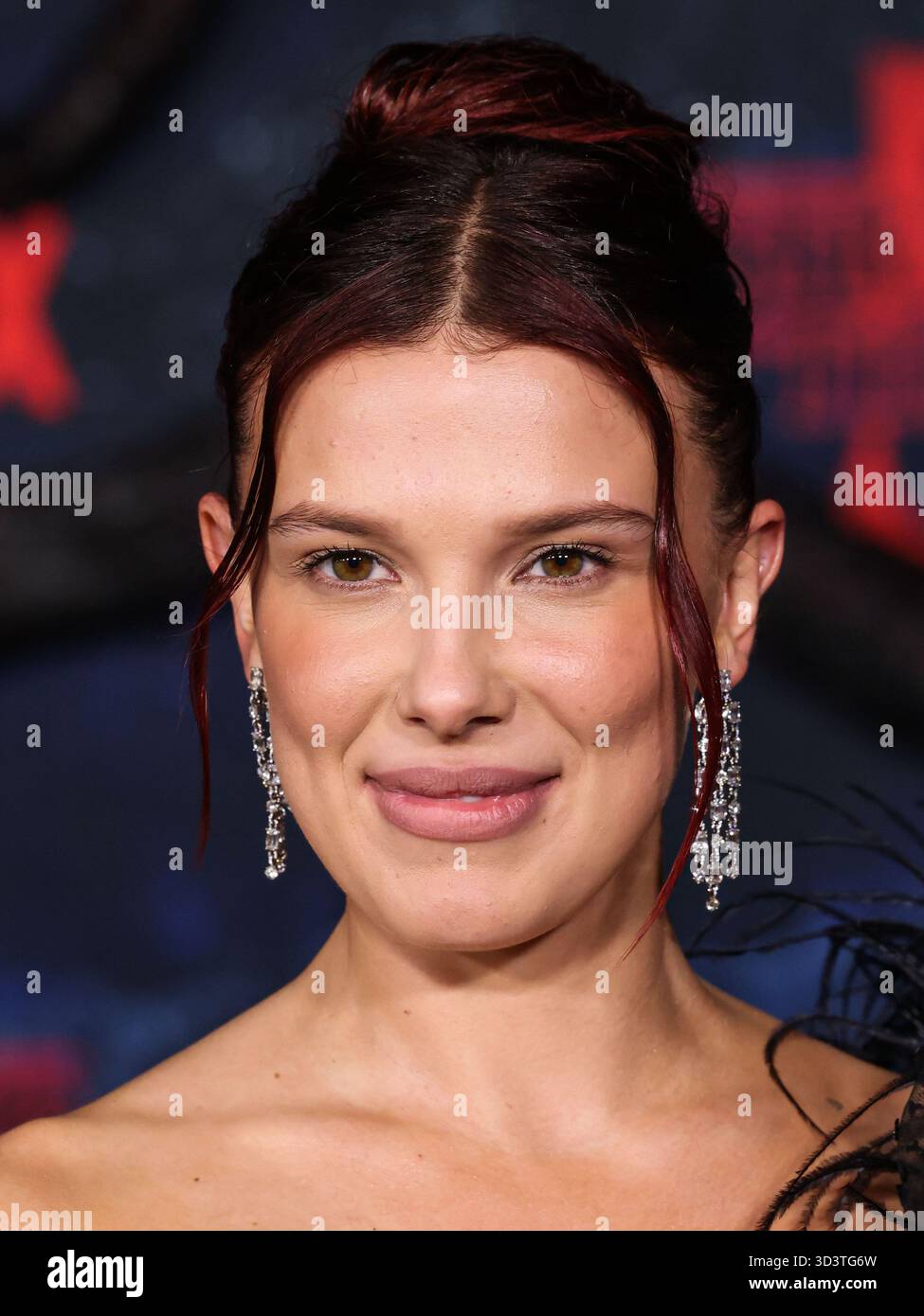 HOLLYWOOD, LOS ANGELES, CALIFORNIA, USA - NOVEMBER 06: British actress and producer Millie Bobby Brown wearing Rodarte and Chopard earrings and a ring, both from the Haute Joaillerie Collection arrives at the HOLLYWOOD, LOS ANGELES, CALIFORNIA, USA - NOVEMBER 06: British actress and producer Millie Bobby Brown wearing Rodarte and Chopard earrings and a ring, both from the Haute Joaillerie Collection arrives at the