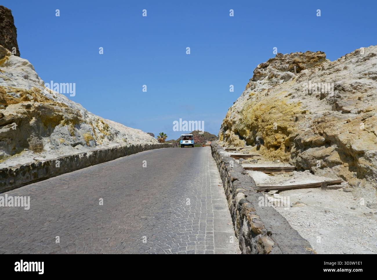 car on cobblestone road through volcanic rocks in Vulcano Island ...
