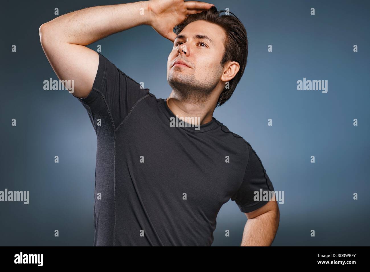 Young handsome man posing on gray background Stock Photo