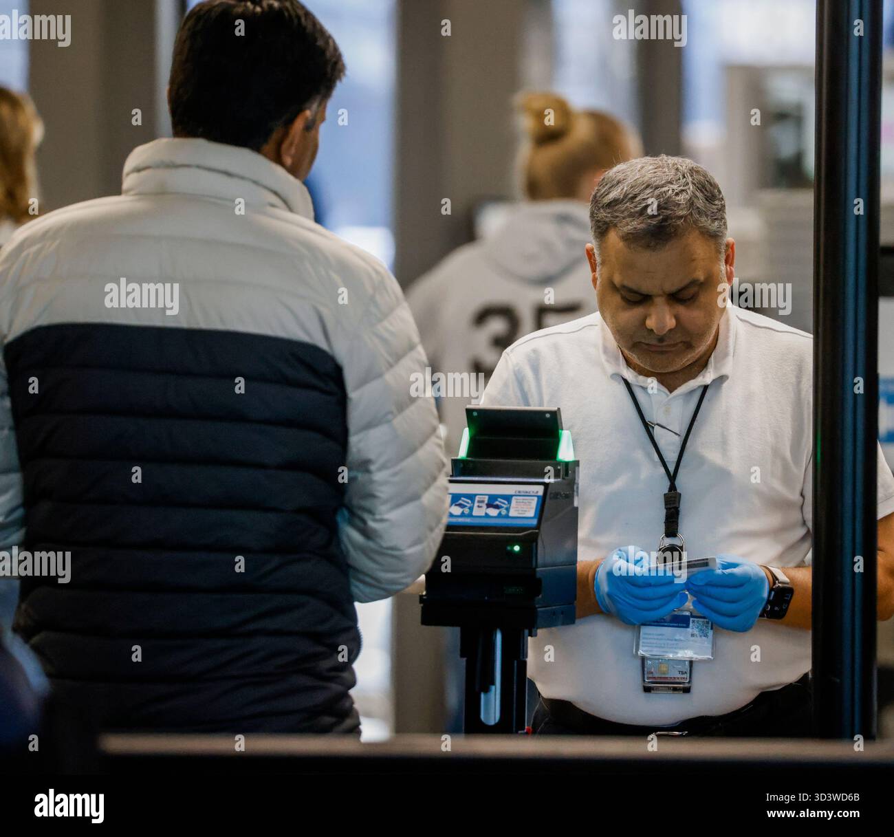 Tsa agent checks identification hi-res stock photography and images - Alamy