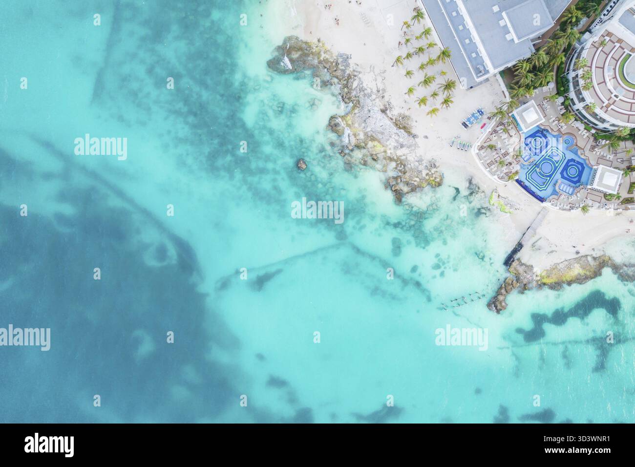 Aerial view of sandy caribbean beach and ocean with rocks and small ...