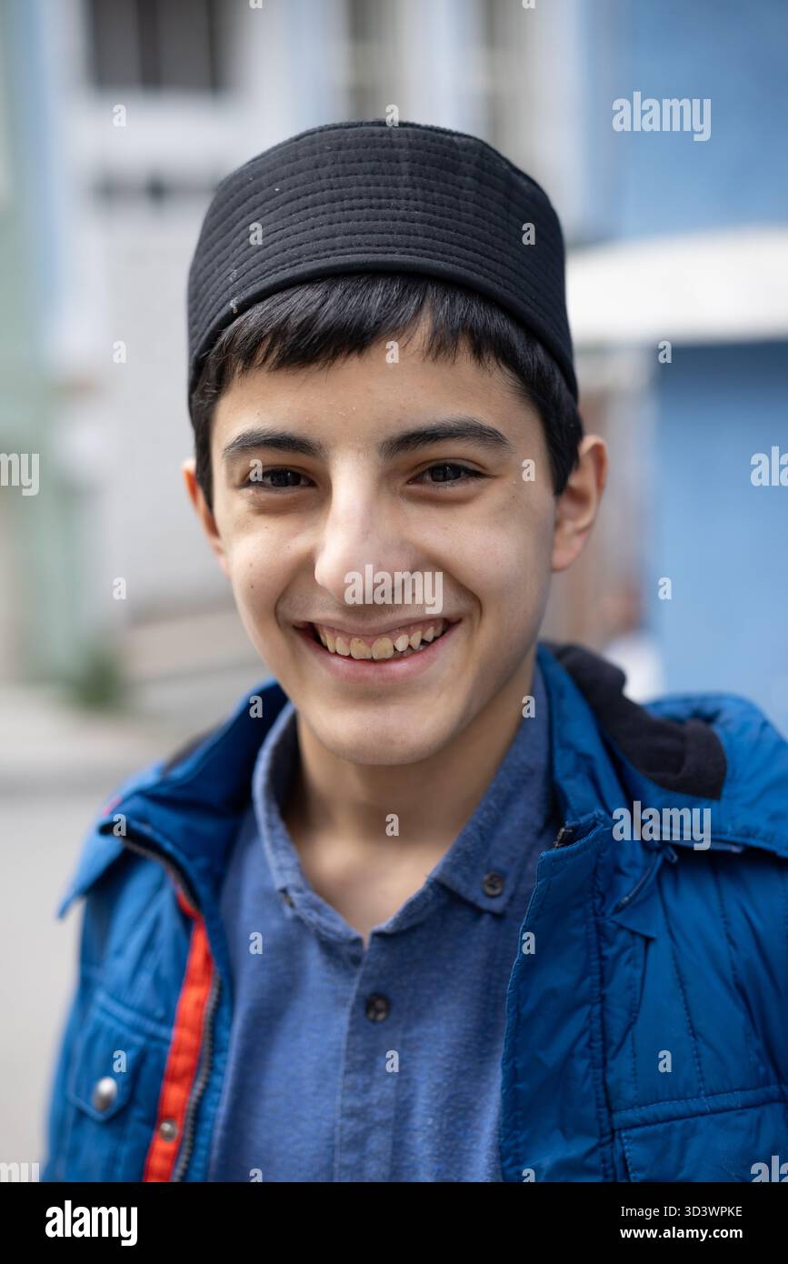 Smiling boy with traditional fez hat in Balat neighborhood of Istanbul, Turkey. Stock Photo
