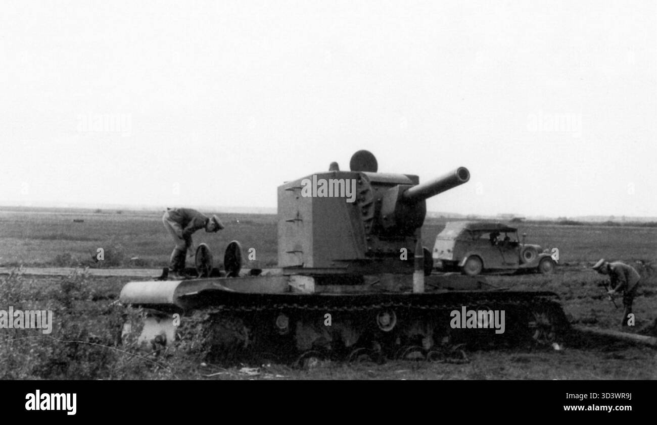 This 1941 photograph shows German forces inspecting a damaged Soviet KV ...