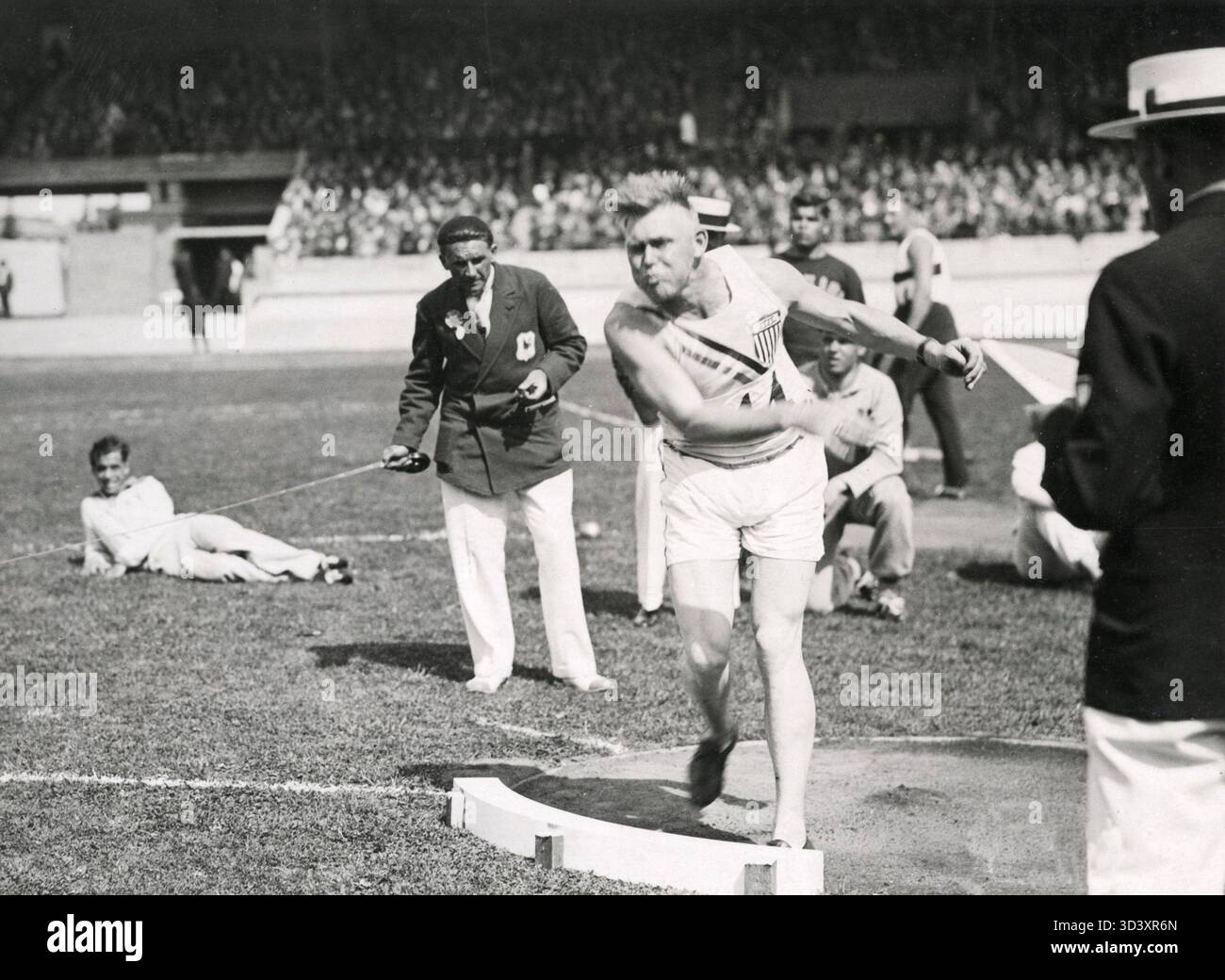 John Kuck, the American shot put champion, winning with a throw of 15. ...