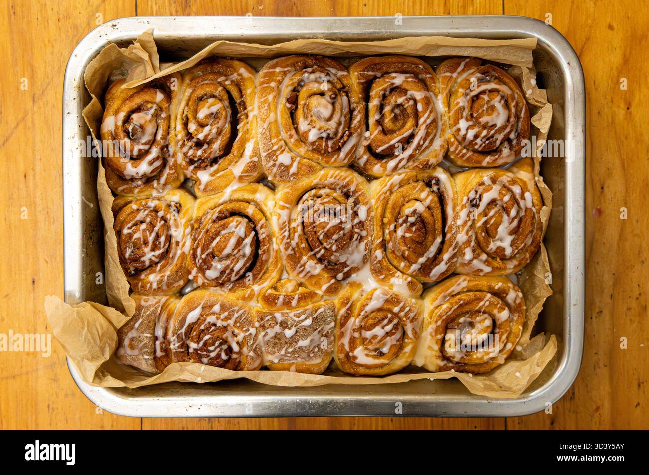 cinnamon buns wooden kitchen table Stock Photo