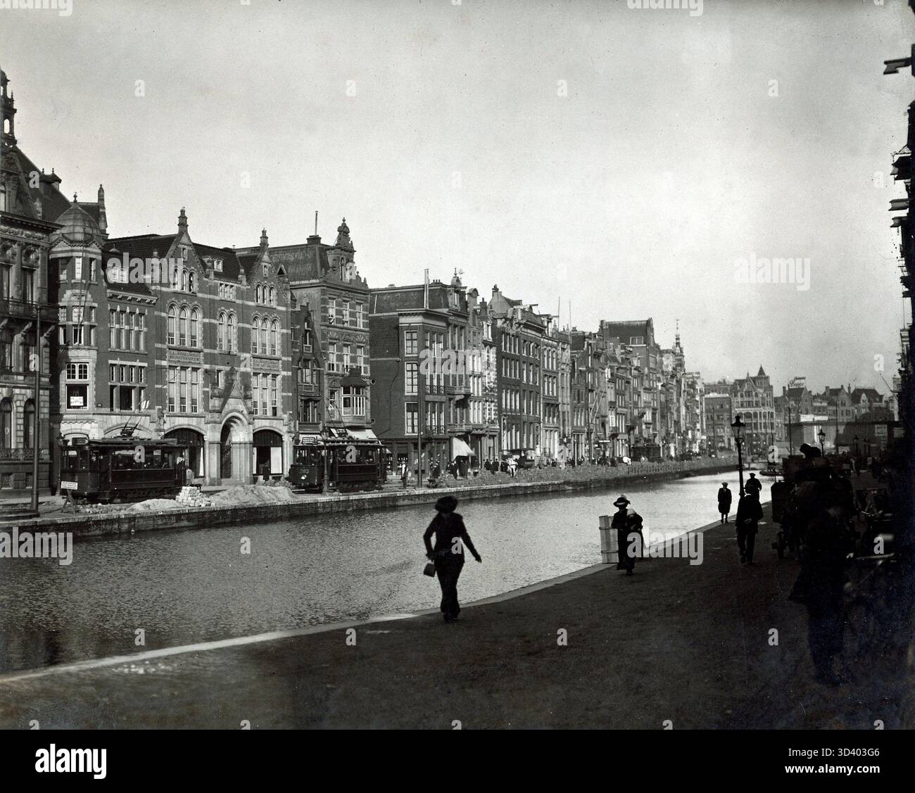 A view of the Rokin in Amsterdam before its infill, with two city trams ...
