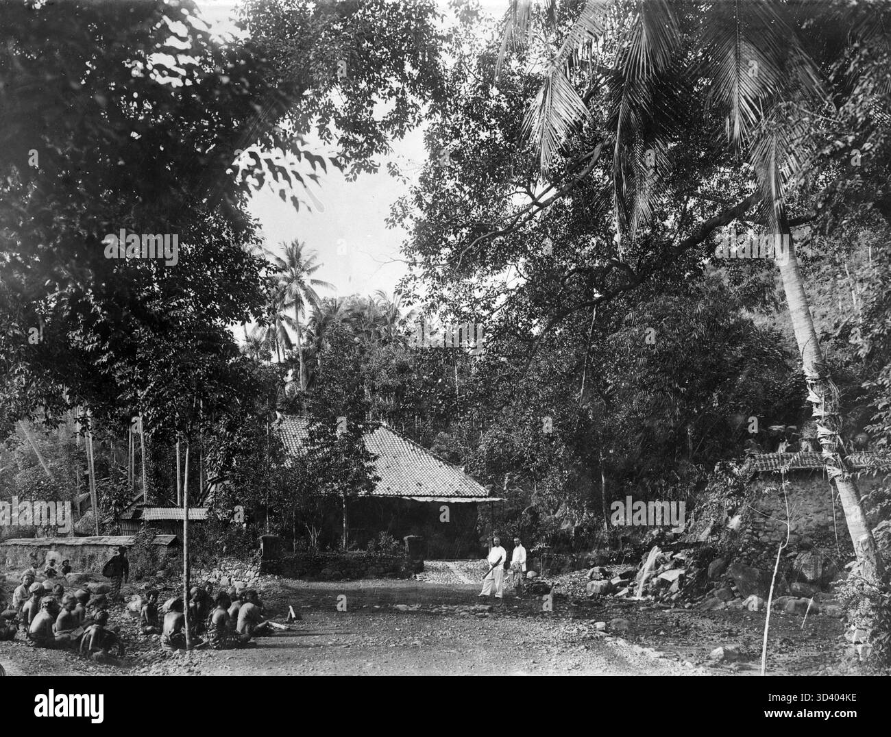 Two European men and a group of Indonesian men standing in front of a ...