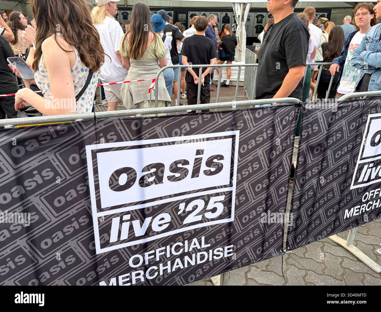 Oasis Live 25 tour, Sydney Accor Stadium, Oasis music fans queue to buy t shirts, bucket hats and mementos from Official merchandise shop, Australia - Smartphone Captured Stock Image