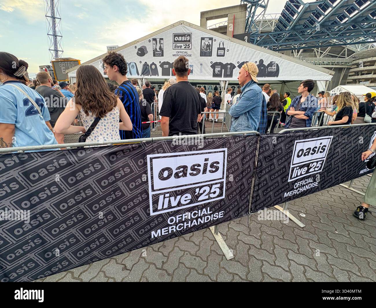 Oasis Live 25 tour, Sydney Accor Stadium, Oasis music fans queue to buy t shirts, bucket hats and mementos from Official merchandise shop, Australia - Smartphone Captured Stock Image