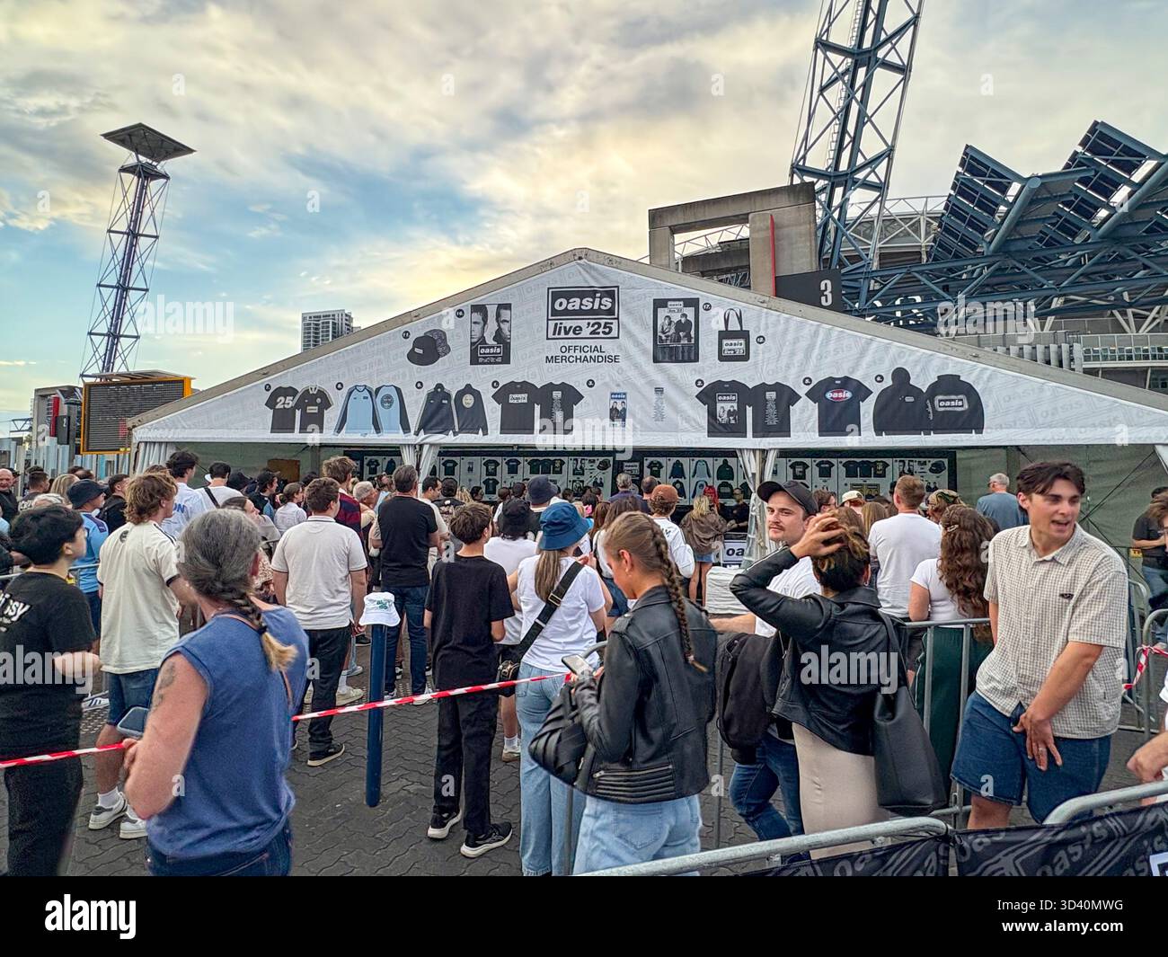 Oasis Live 25 tour, Sydney Accor Stadium, Oasis music fans queue to buy t shirts, bucket hats and mementos from Official merchandise shop, Australia - Smartphone Captured Stock Image