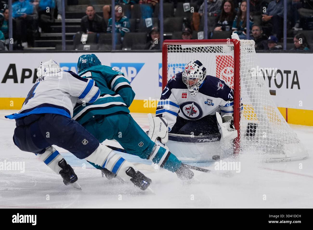 Connor Block Winnipeg Jets goaltender Connor Hellebuyck (37) blocks a shot by San ...