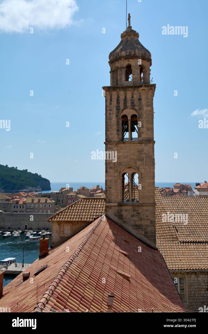 The stone bell tower of the Franciscan Monastery rises above terracotta ...