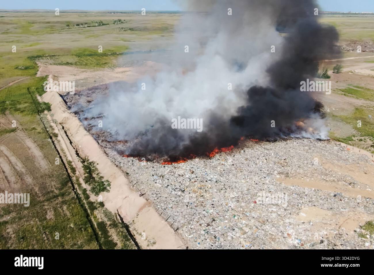 Burning trash. fire at the landfill. Burning garbage. Garbage dump, top ...
