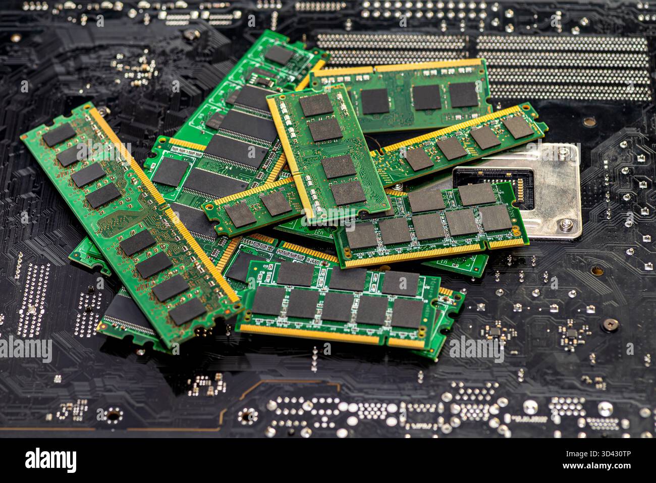 A stack of old SDRAM memory modules lying on a printed circuit board. Stock Photo
