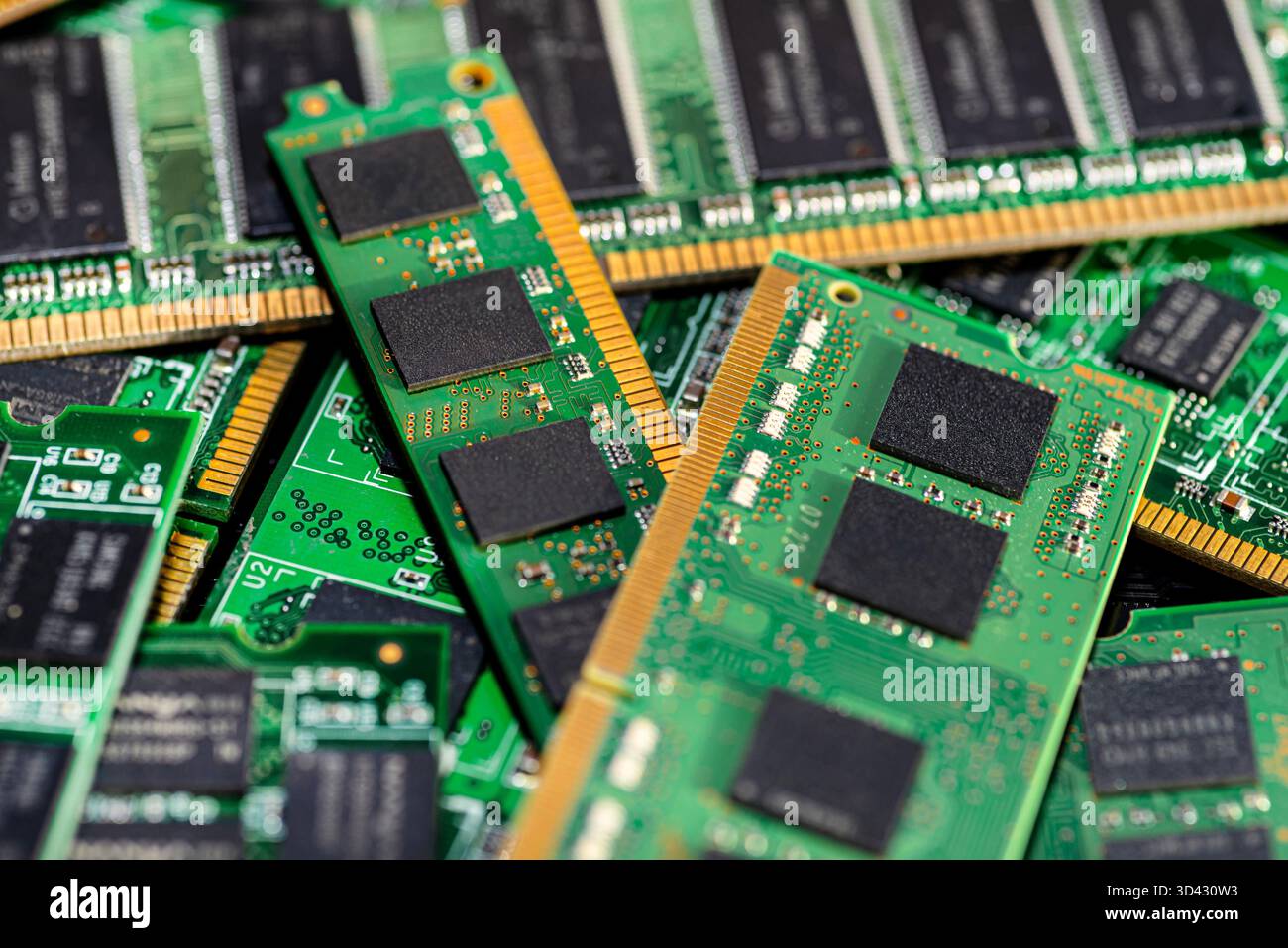 A stack of old SDRAM memory modules lying on a printed circuit board. Stock Photo