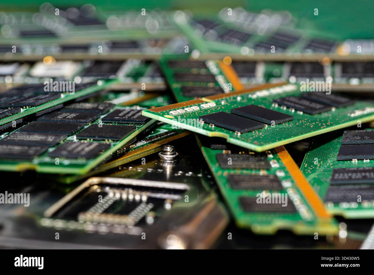 A stack of old SDRAM memory modules lying on a printed circuit board. Stock Photo