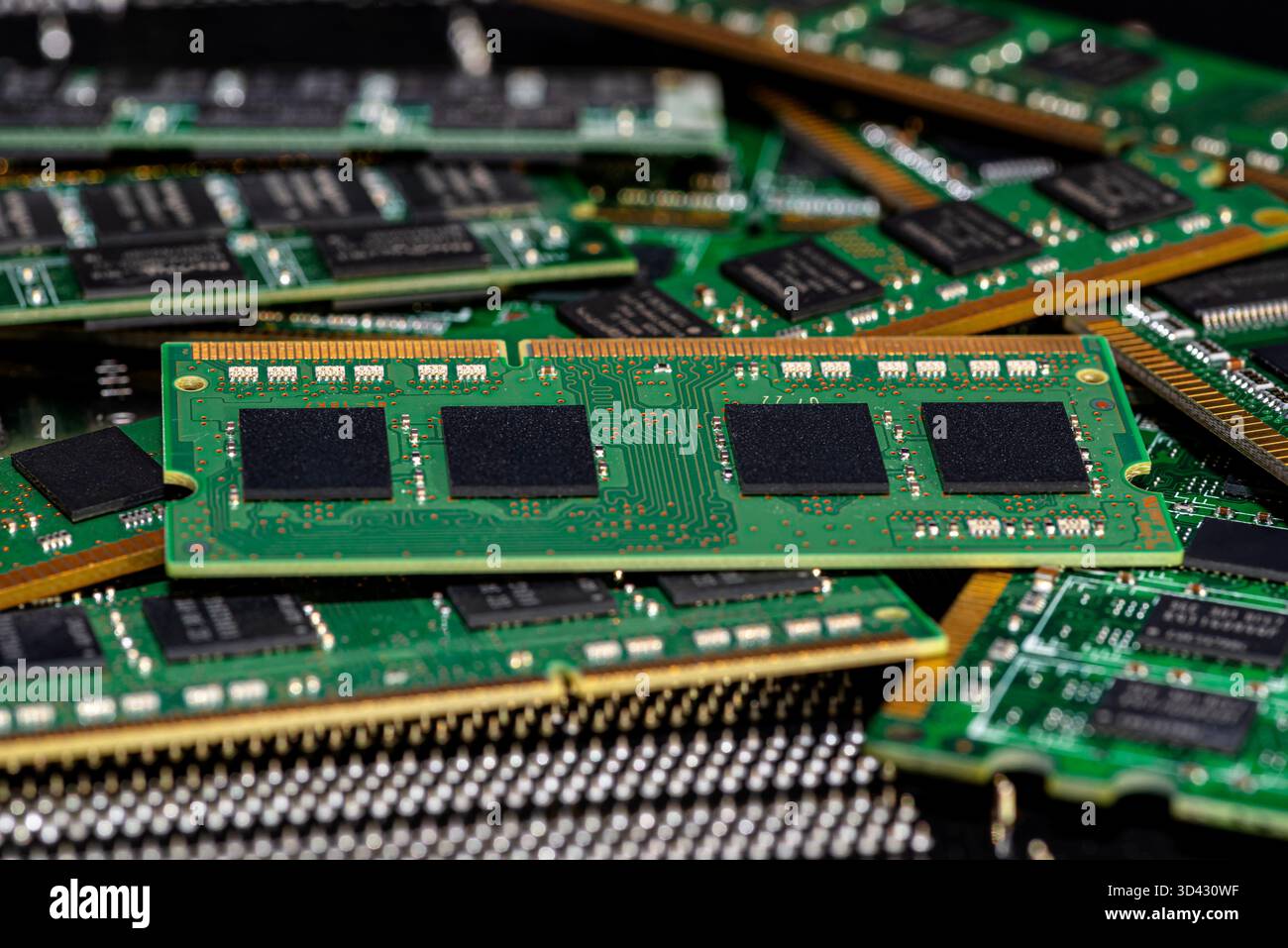 A stack of old SDRAM memory modules lying on a printed circuit board. Stock Photo