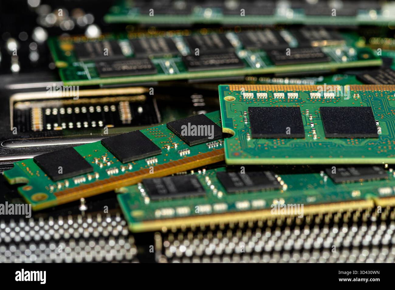 A stack of old SDRAM memory modules lying on a printed circuit board. Stock Photo