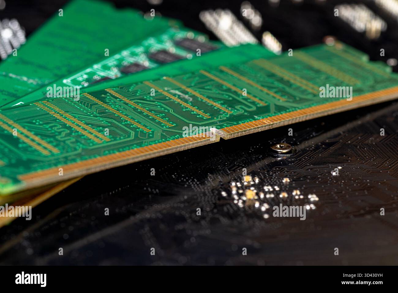 A stack of old SDRAM memory modules lying on a printed circuit board. Stock Photo