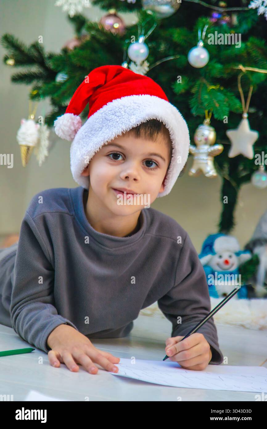 A boy writes letters to Santa Claus and Saint Nicholas under the ...