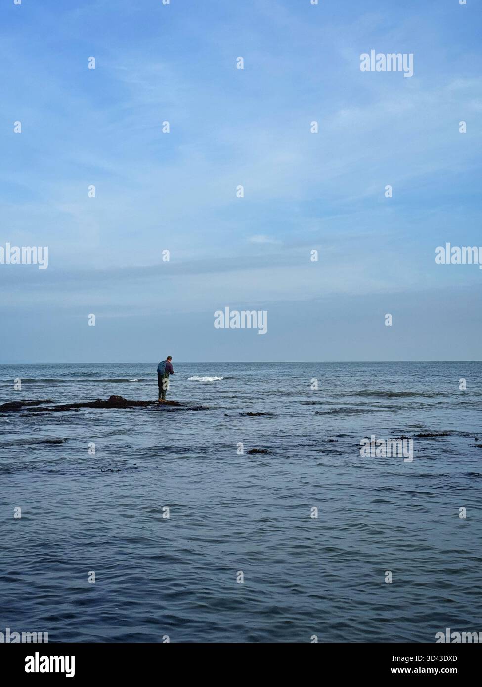 Lone sea angler at Port Eynon, Swansea, Gower, Wales. - Smartphone Captured Stock Image