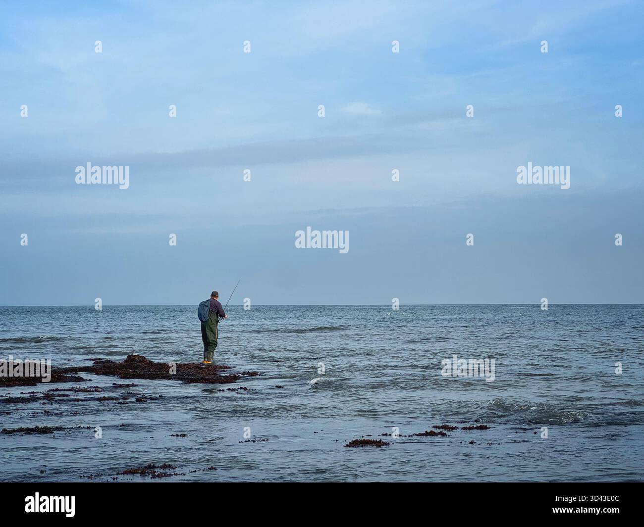 Lone sea angler at Port Eynon, Swansea, Gower, Wales. - Smartphone Captured Stock Image
