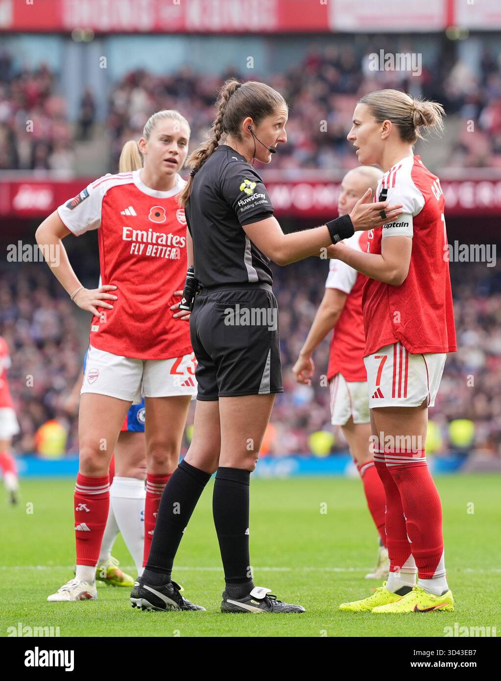 Referee Melissa Burgin talks to Arsenal players after disallowing their ...