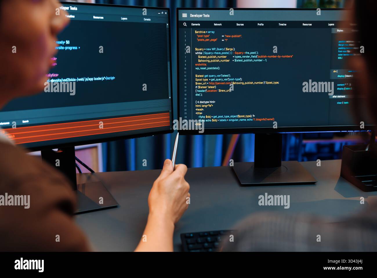 Smart IT developer looking at coding program application on computer screen of online website at back side, analyzing intelligent database system Stock Photo