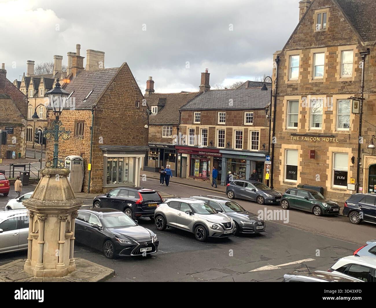 Uppingham Rutland square cars shop shops car old stone history school hotel park parking kids people place village shopping post office shopping - Smartphone Captured Stock Image