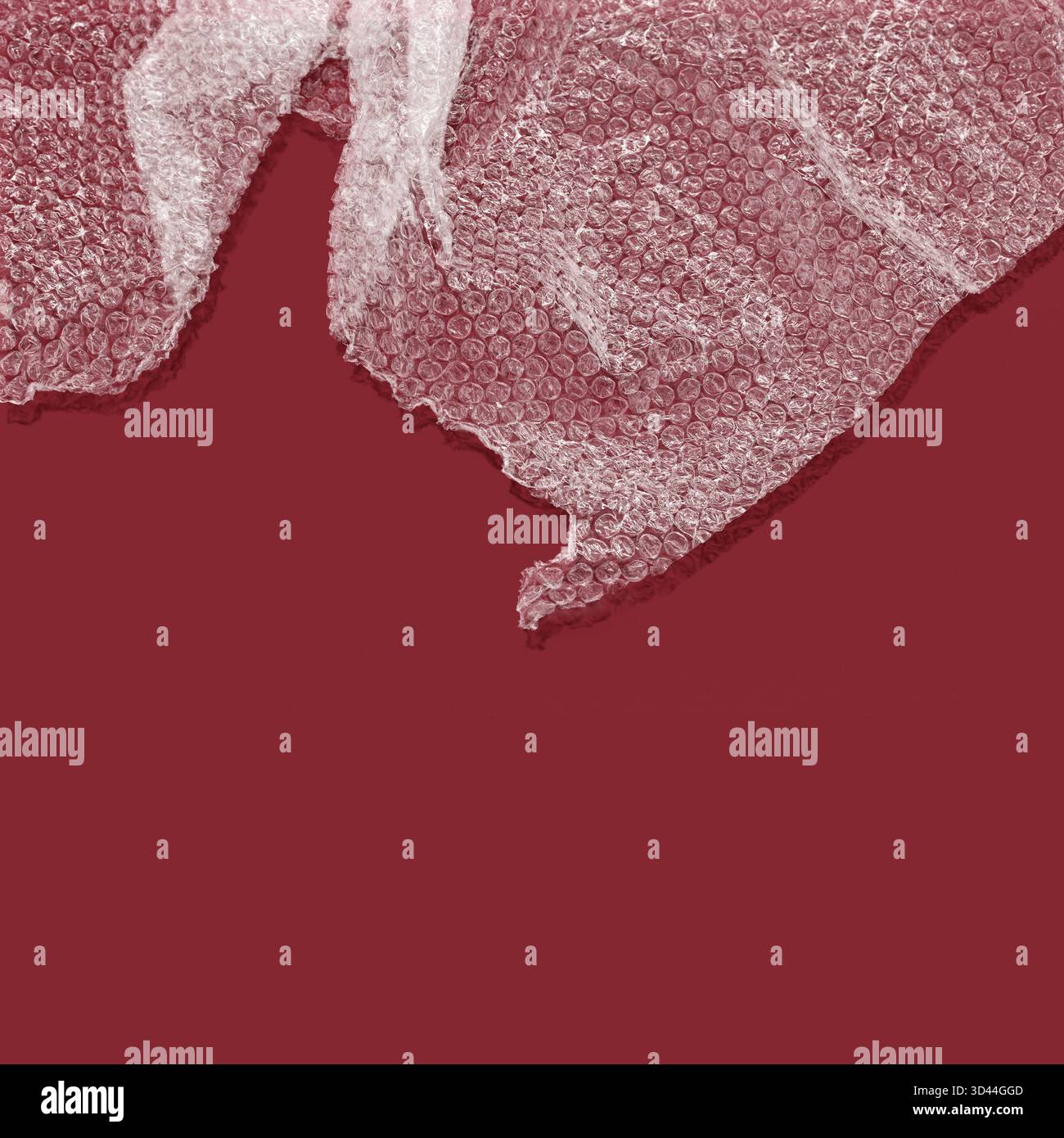 Bubble wrap with shadow against red background Stock Photo