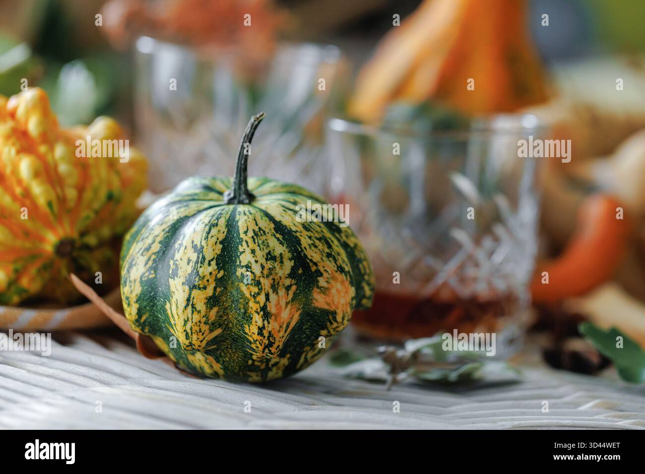 Harvest decor with whiskey and striped cloth Stock Photo