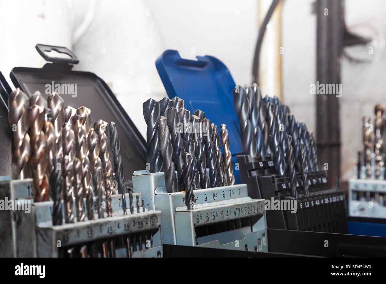 Sets of drills on a table in a workshop. Stock Photo