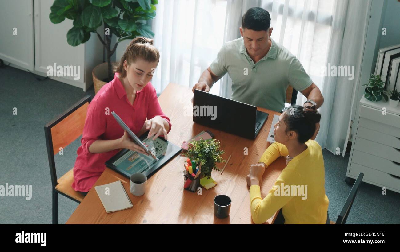 Top down view of project manager present idea while holding tablet at meeting. Skilled business team discussing and planning marketing strategy. Group Stock Photo