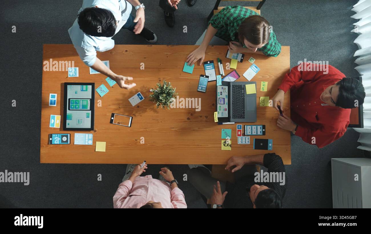 Top view of developer and designer shake hand together at meeting. Software developer handshake and working together with programmer to develop Ux Ui Stock Photo