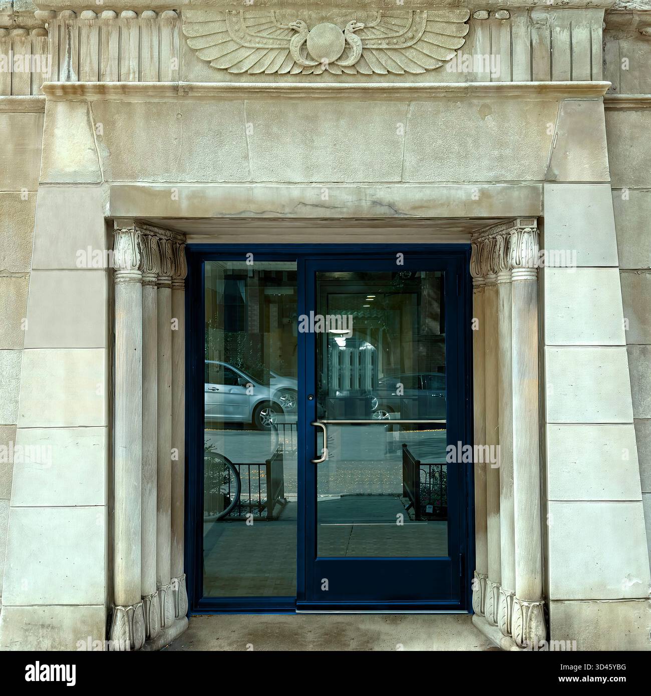 Doorway framed by carved limestone Art Deco Egyptian Revival motifs in Chicago - Smartphone Captured Stock Image