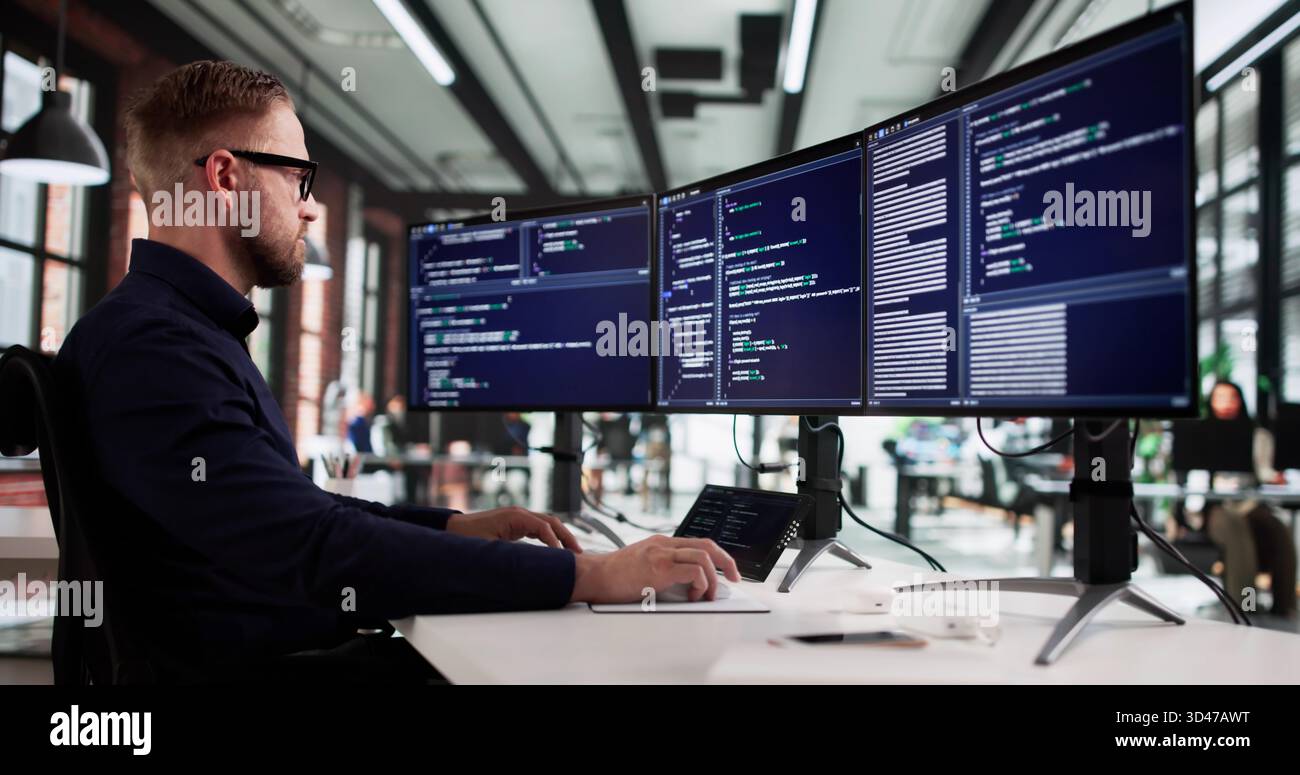 Tech-savvy Programmer Creates Innovative Code On Office Desktop Computer Screen. Stock Photo
