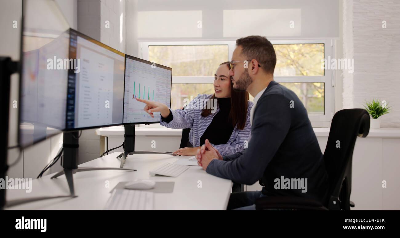 Financial Advisor And Accountant Analyzing Data In Modern Office Stock Photo