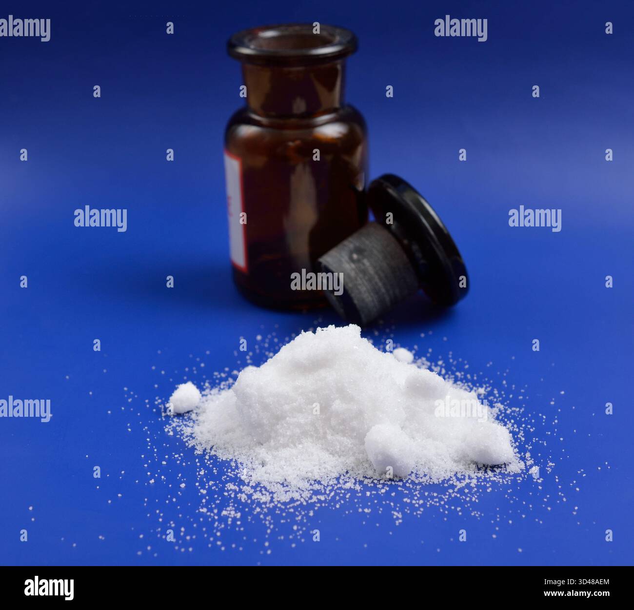 Thiourea powder on blue background Stock Photo