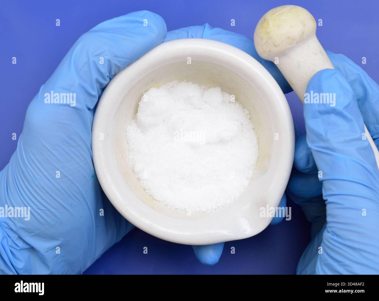 Thiourea powder on blue background Stock Photo