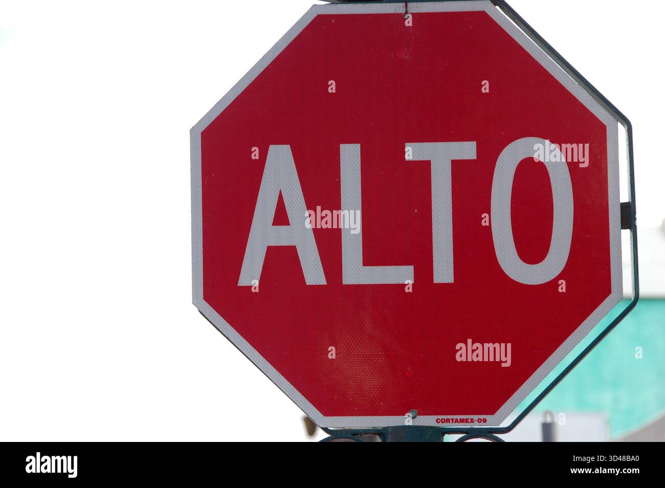 Red octagonal ALTO stop sign in Spanish, captured up close against a ...