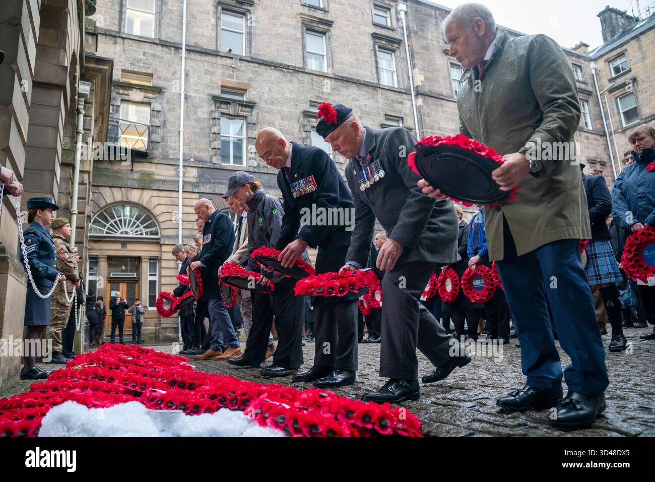 People lay wreaths during a Remembrance Sunday ceremony at the Stone of ...