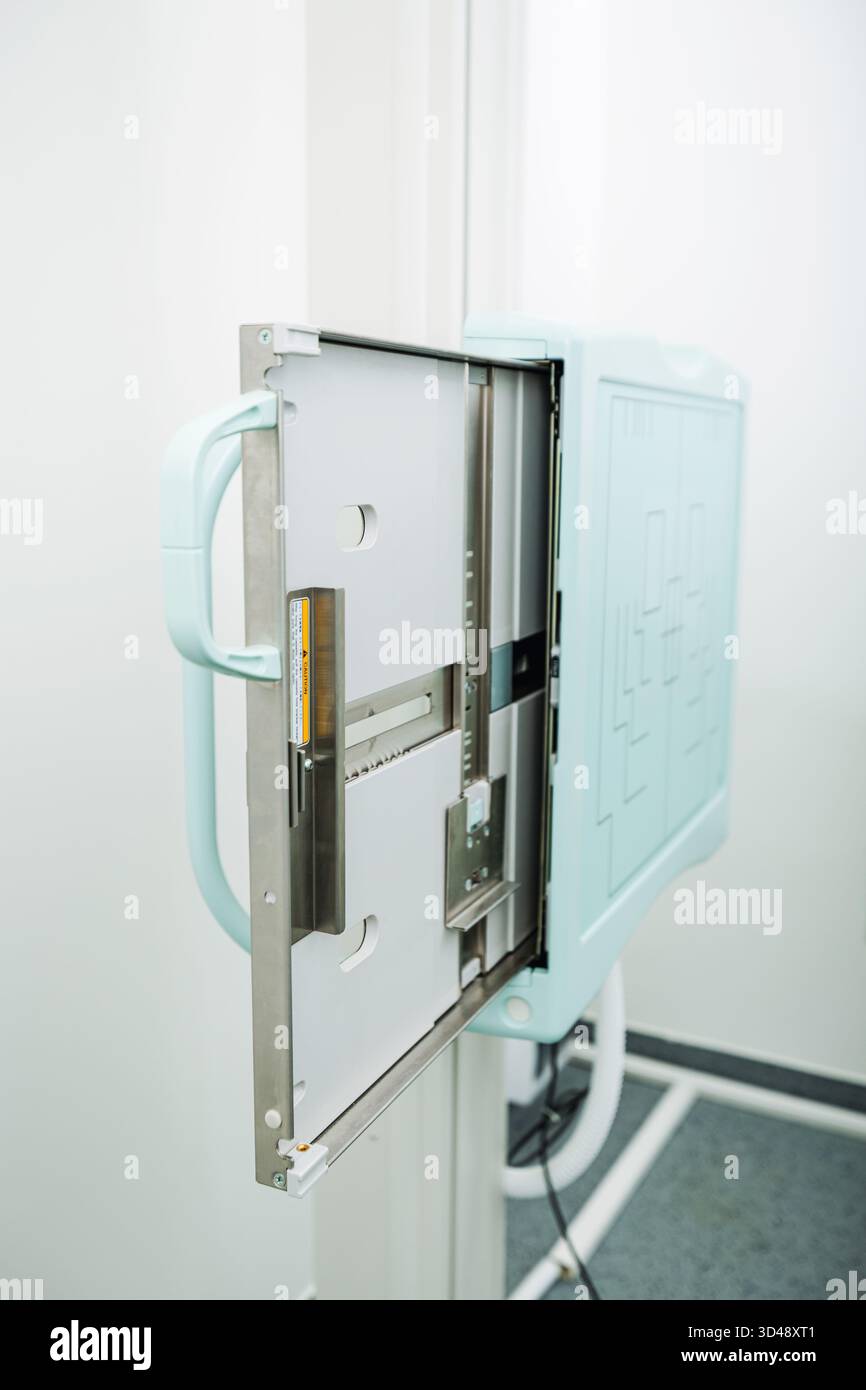 Close-up of X-ray detector being checked for cleanliness and stability during maintenance at medical imaging facility. Stock Photo