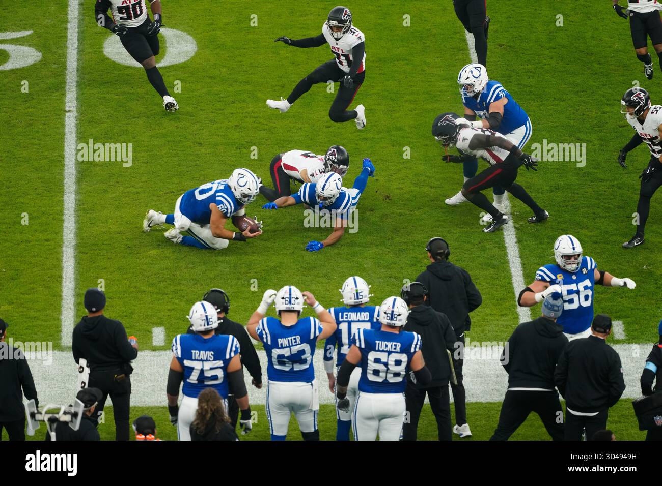 Indianapolis Colts center Tanor Bortolini saves the ball ahead of the ...
